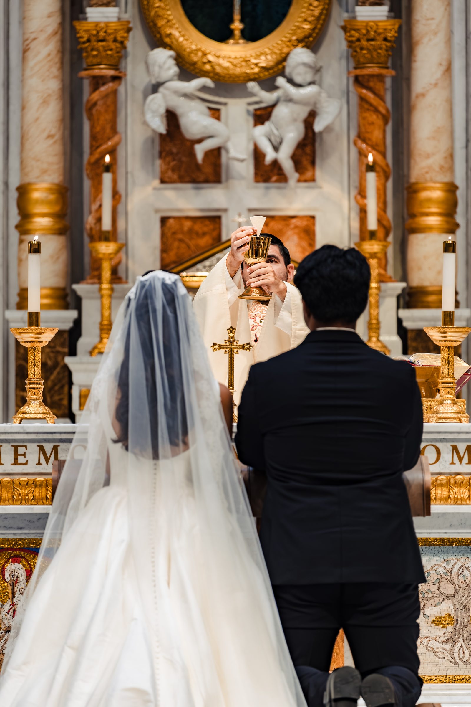 The elevation of the chalice above the kneeling couple