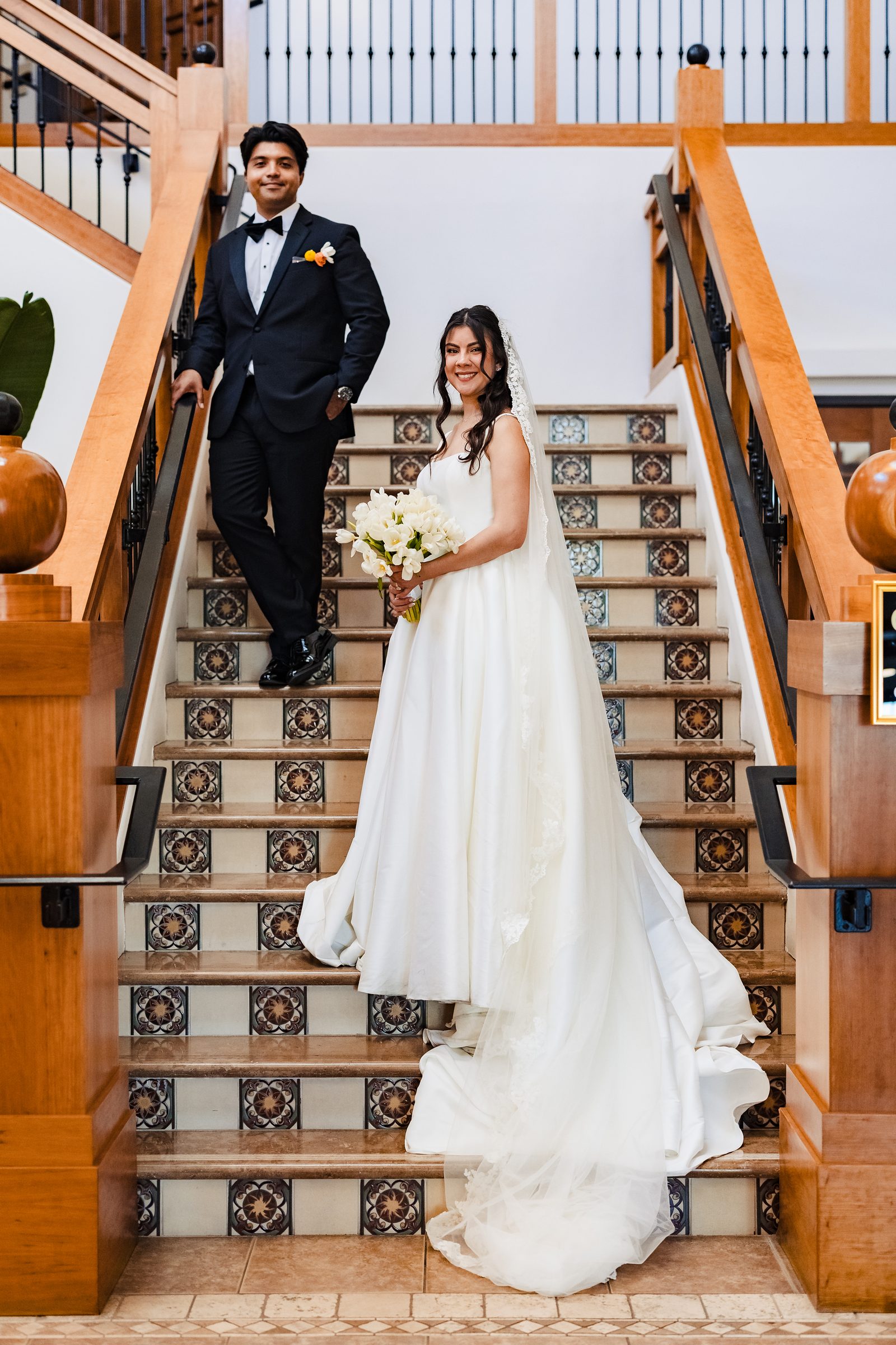The newlyweds on a tiled staircase in Laguna Hills