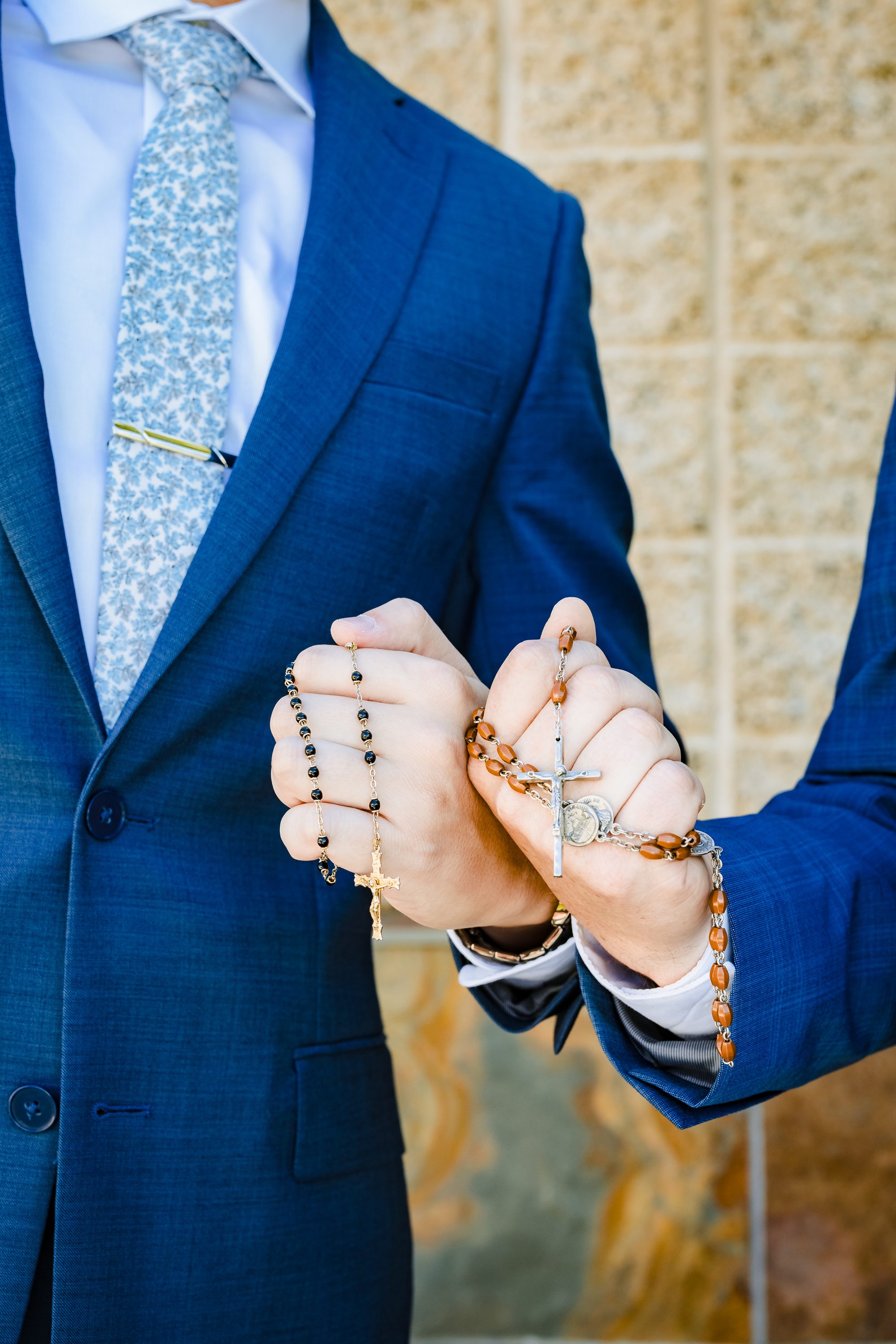 Guillermo holding two rosaries before the Nuptial Mass