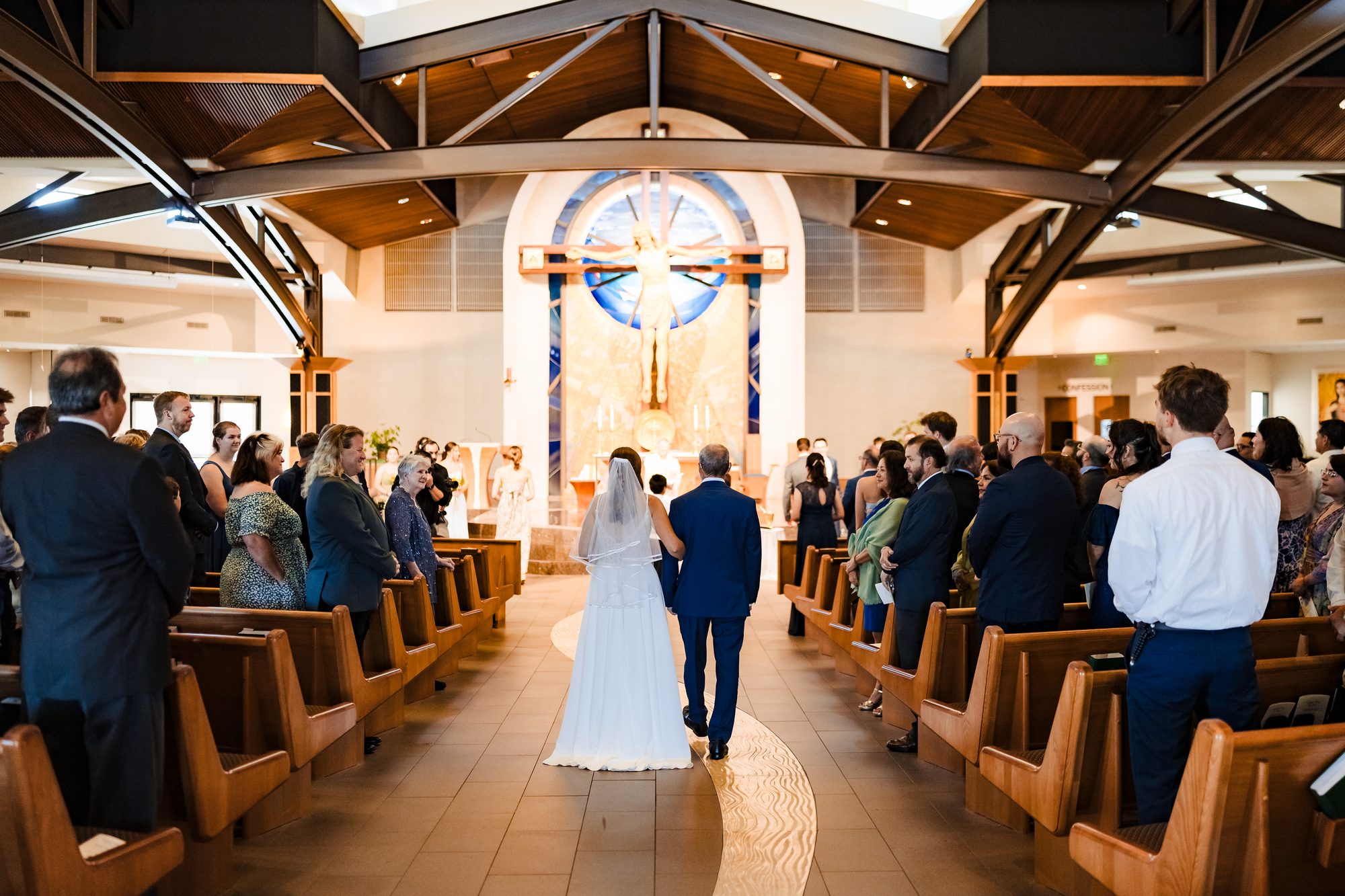 The groom walks in with his mother before the ceremony