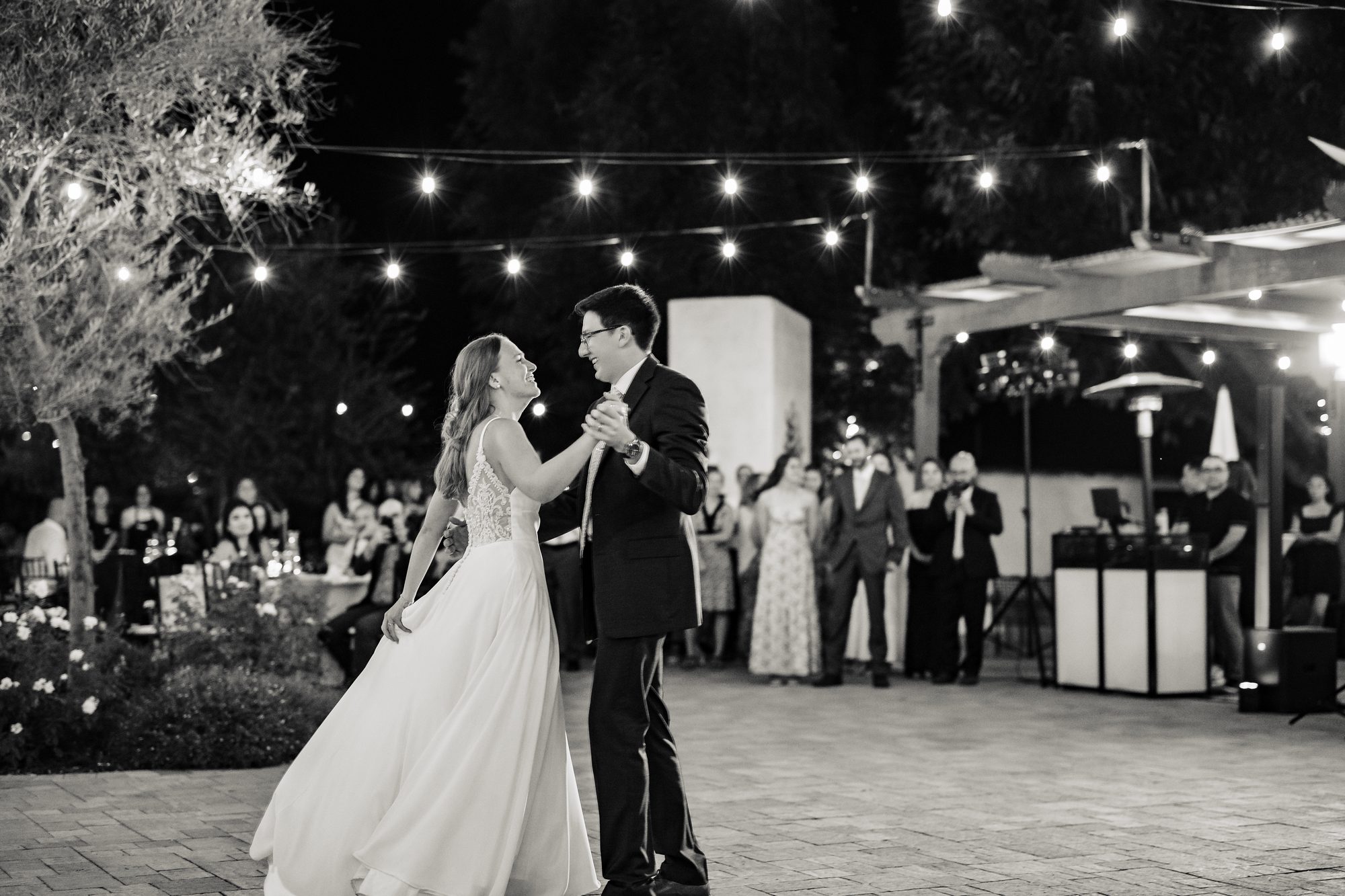 Guests gather under string lights at the evening reception