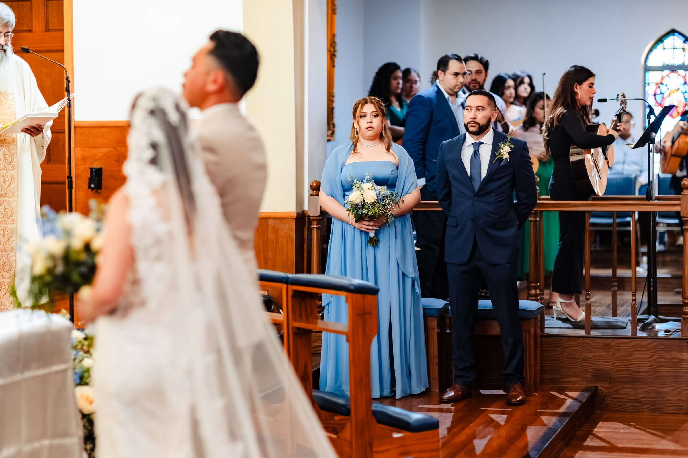 The bridal party standing as the couple reaches the altar