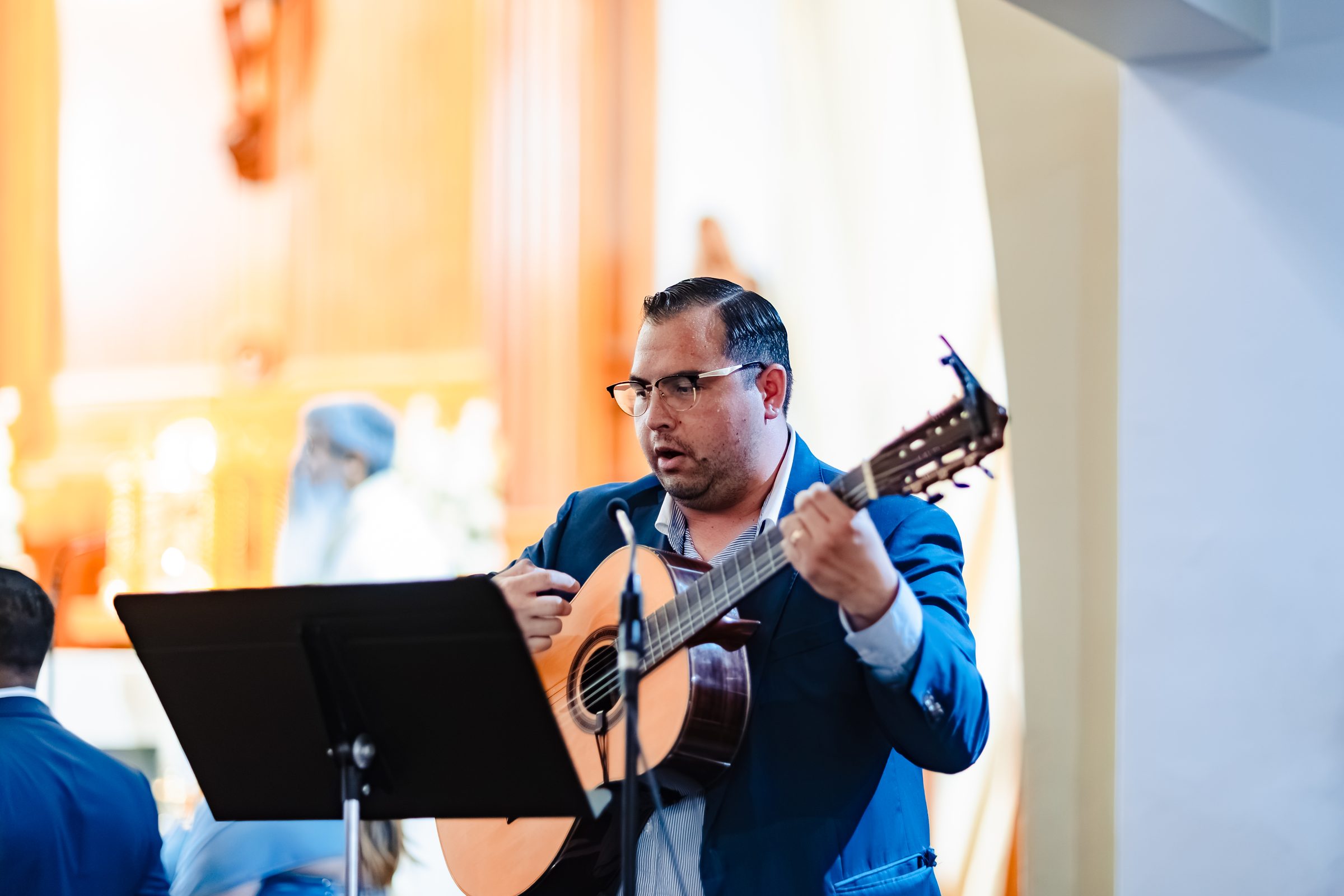 A guitarist leading music during the Nuptial Mass