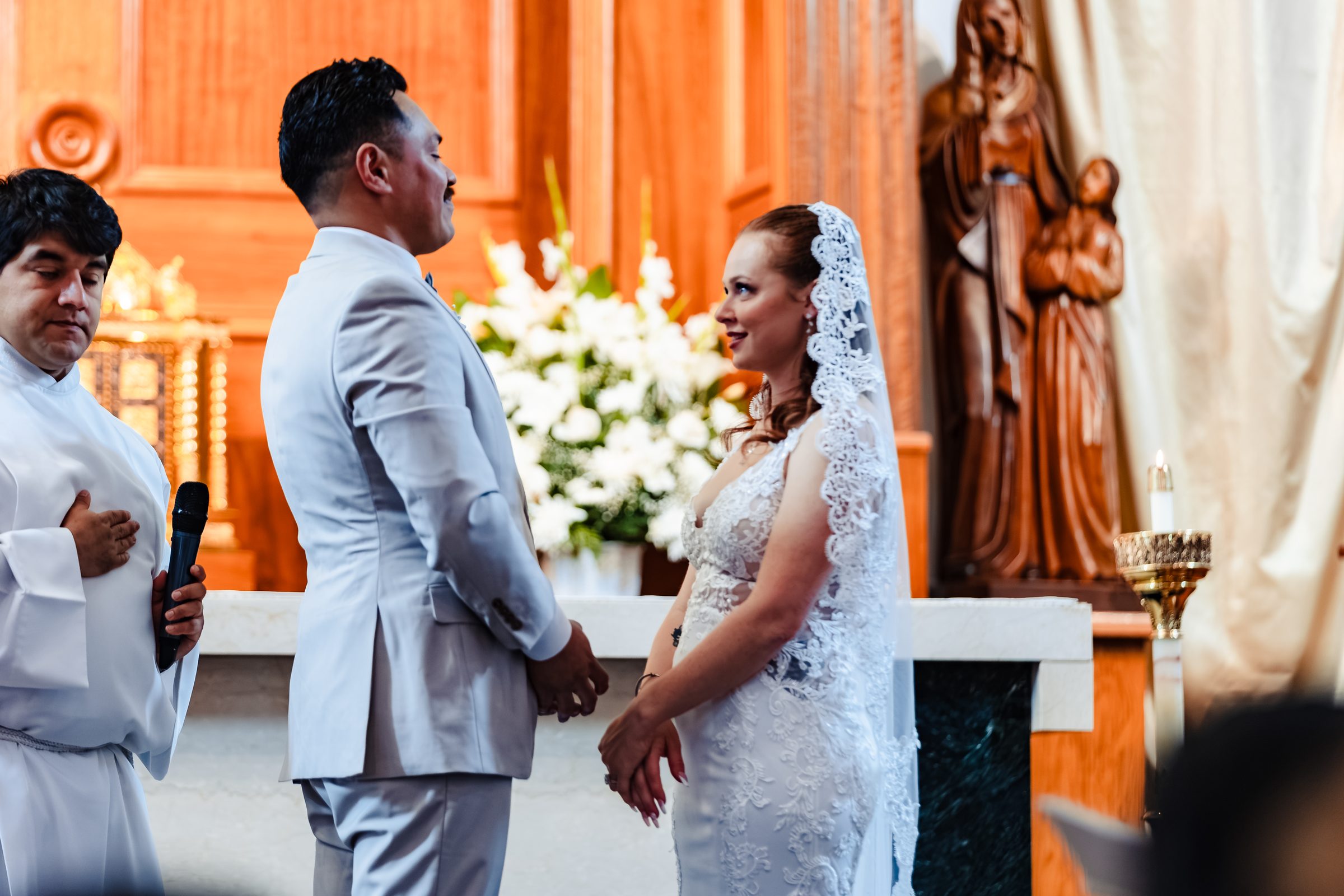 Isaac and Brittany exchanging vows before the altar