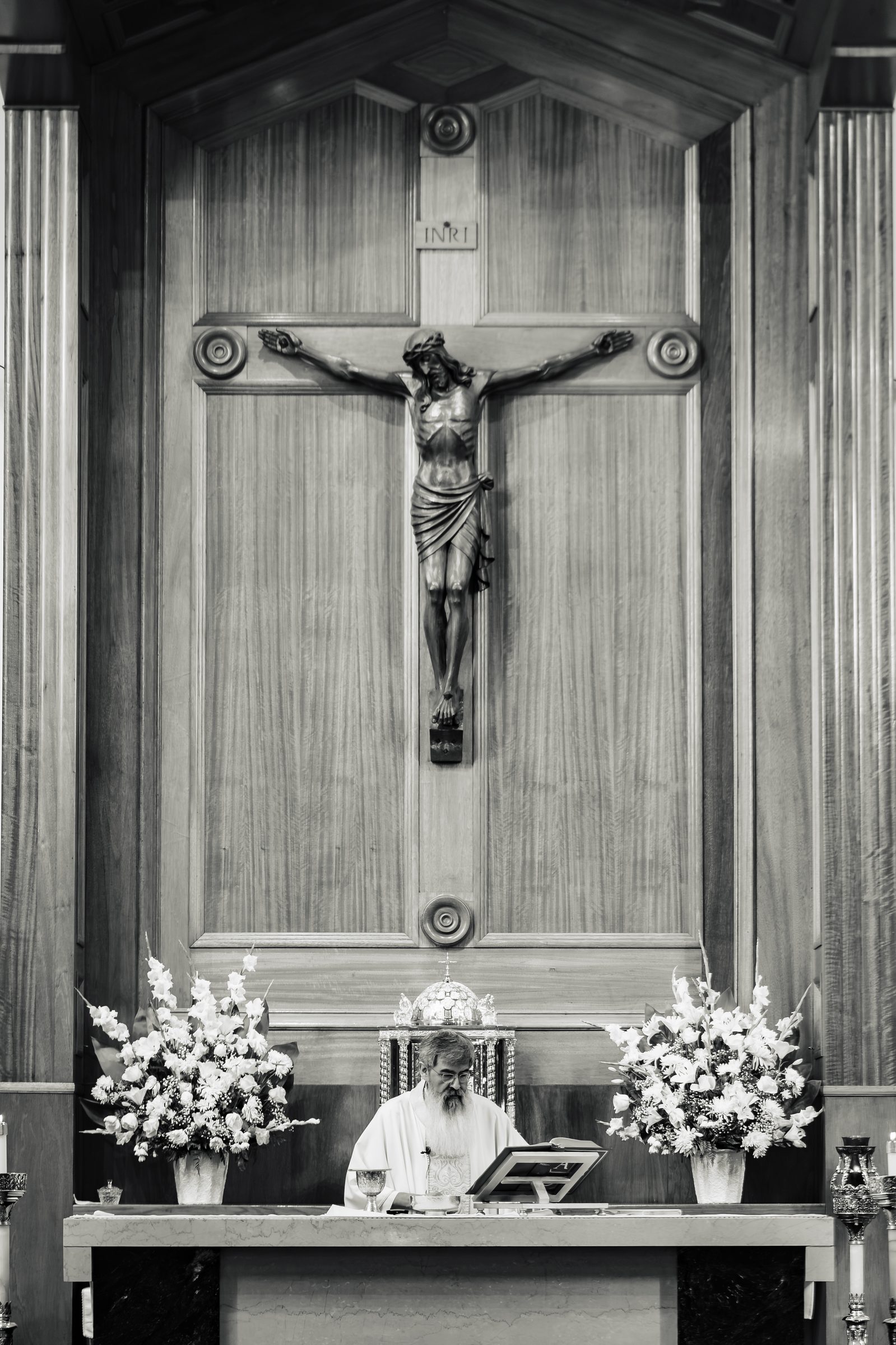 Black and white of the crucifix and altar during the Mass