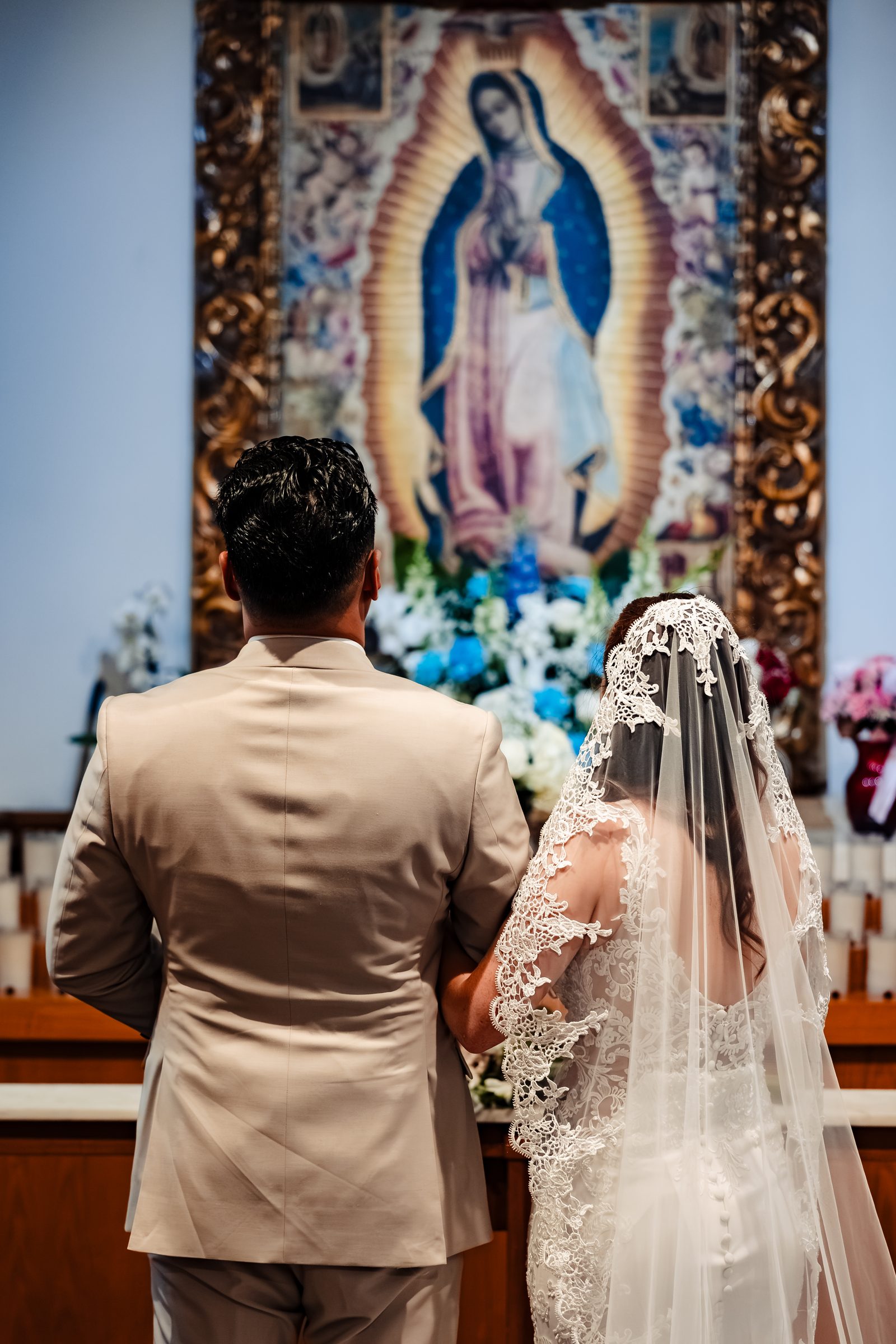 The newlyweds before the image of Our Lady of Guadalupe