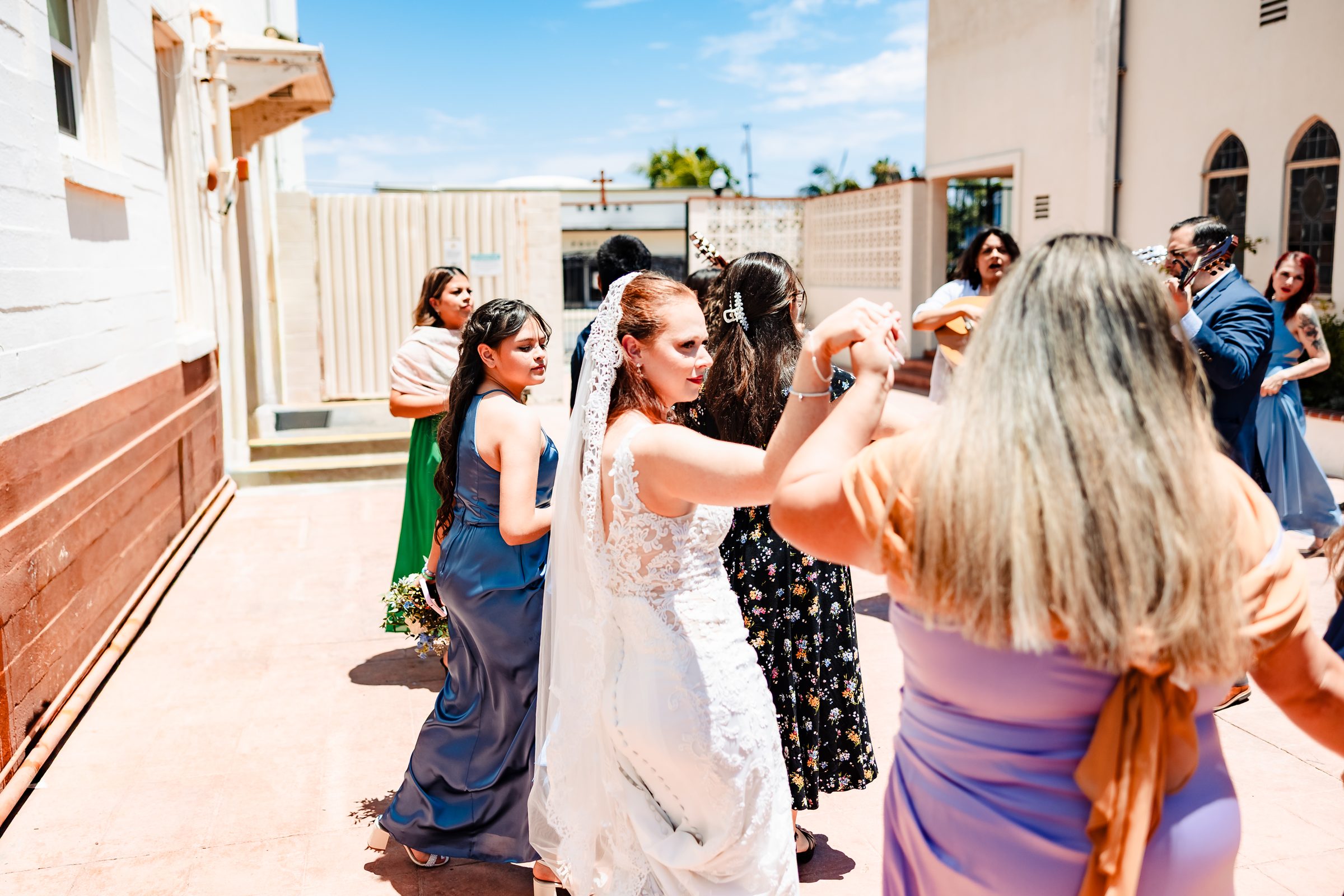 Brittany dancing with guests outside the church