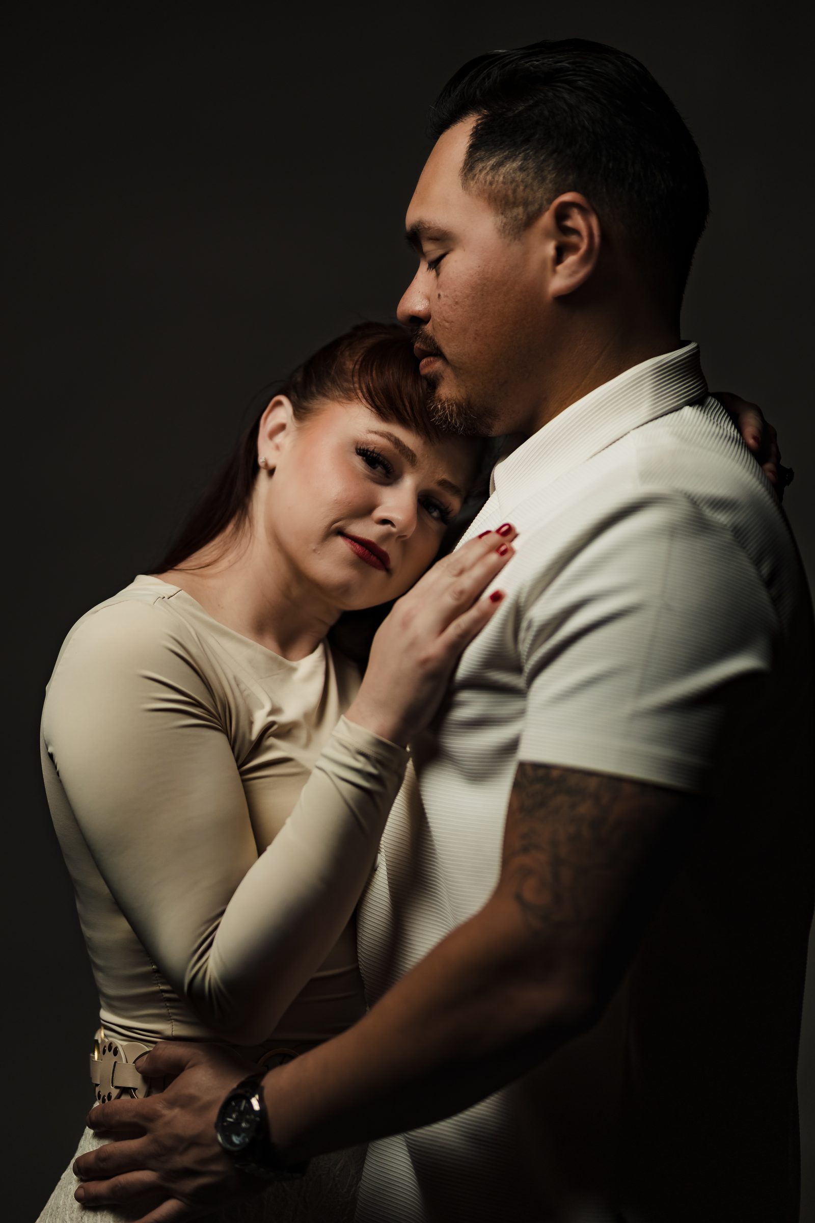 Brittany resting her head on Isaac, studio engagement portrait