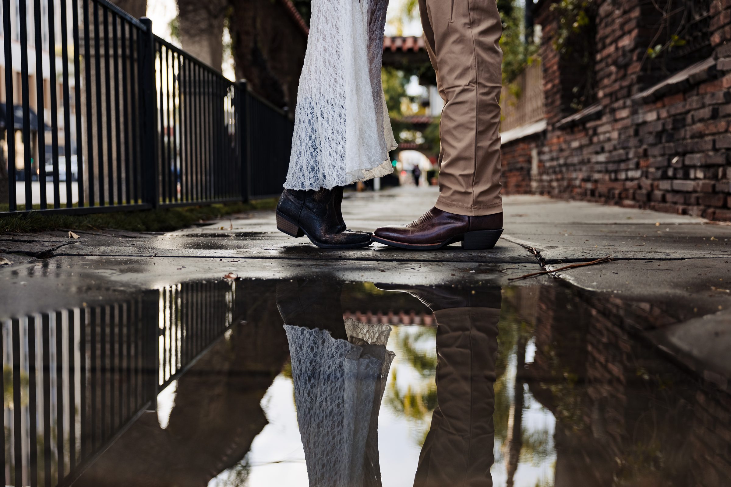 Reflections in a rain puddle during the Mission Inn engagement session