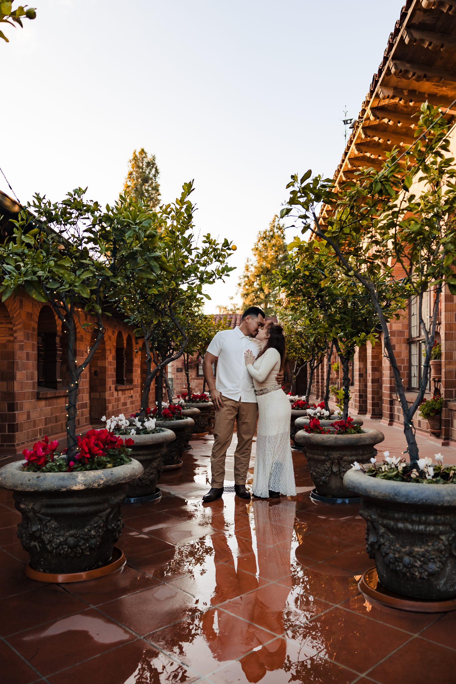 A kiss on the rain-washed terrace of the Mission Inn