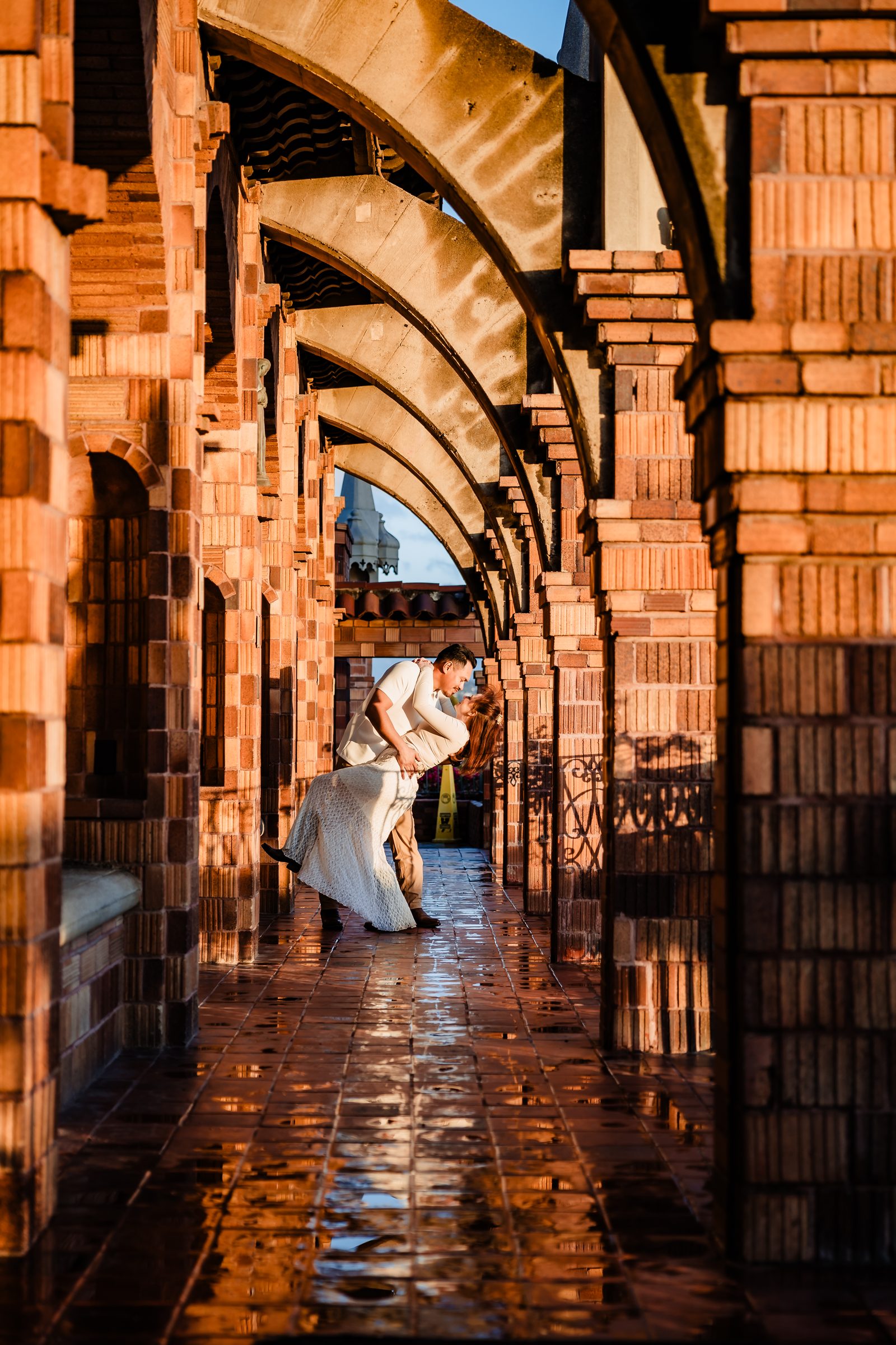 Isaac dipping Brittany beneath the brick arcade of the Mission Inn