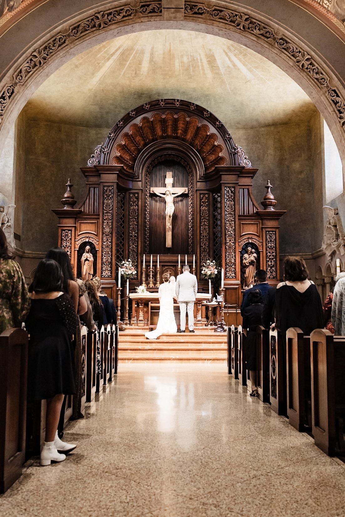 The couple before the high altar seen down the center aisle