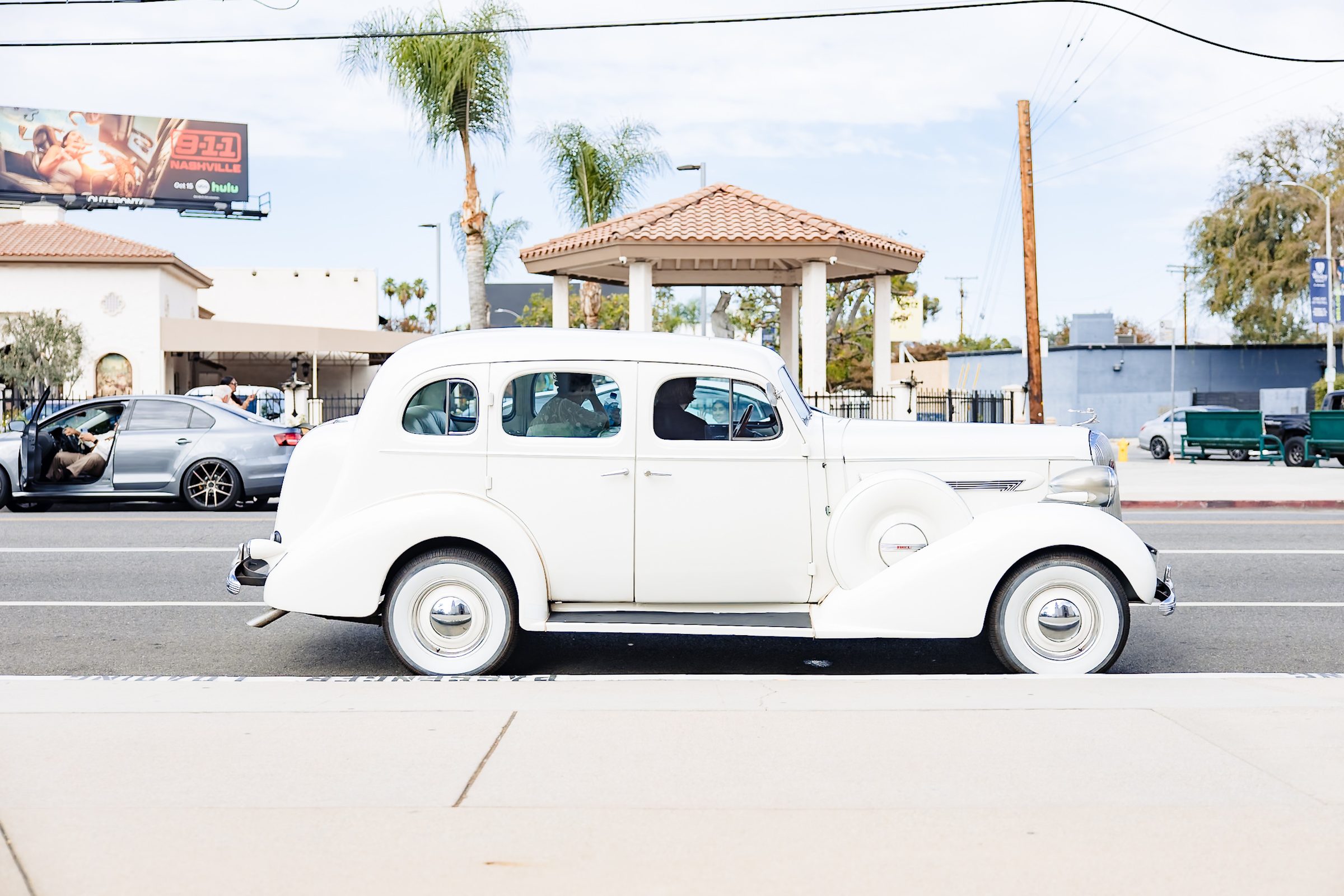 The white classic Chrysler parked outside St. Charles Borromeo