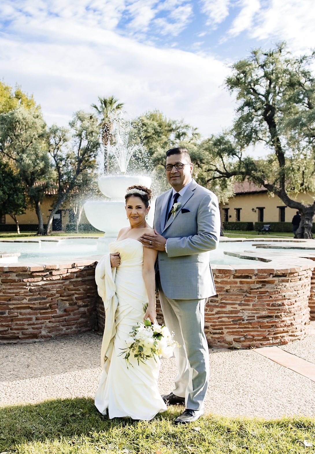The couple before the fountain at Mission San Fernando Rey de España
