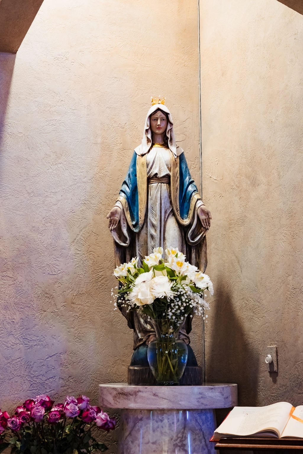 The Immaculate Conception statue with flowers at St. Albert the Great