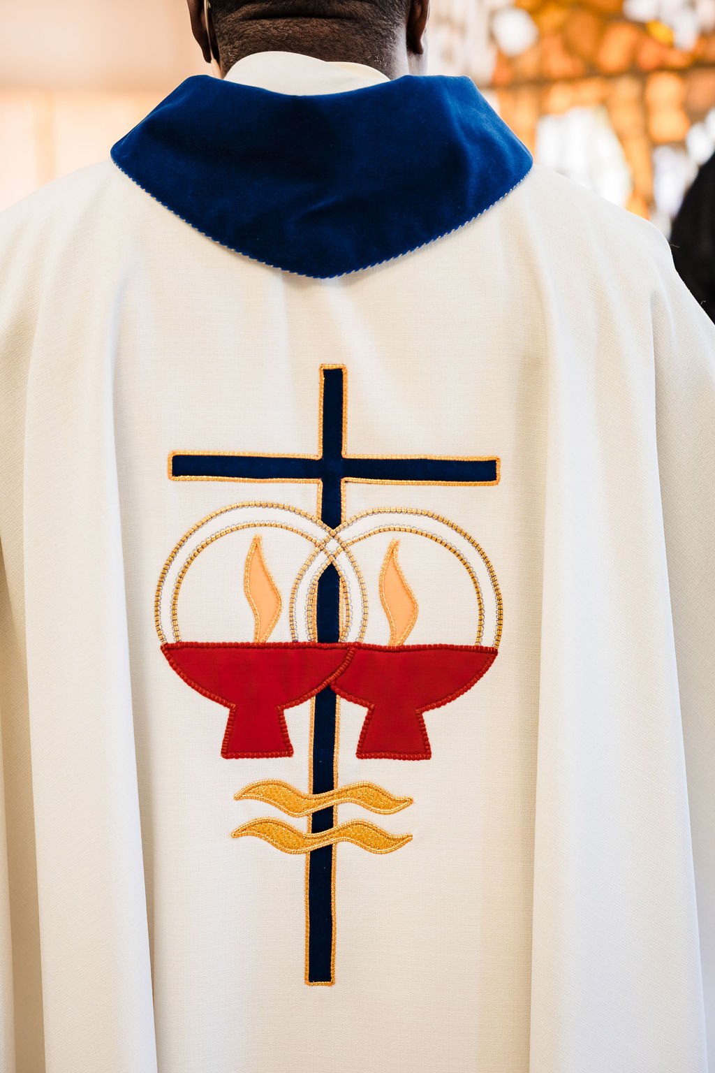 The celebrant's chasuble embroidered with the cross and wedding rings