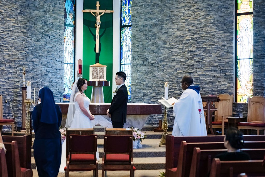 Vincent and Ginger exchanging vows before the priest