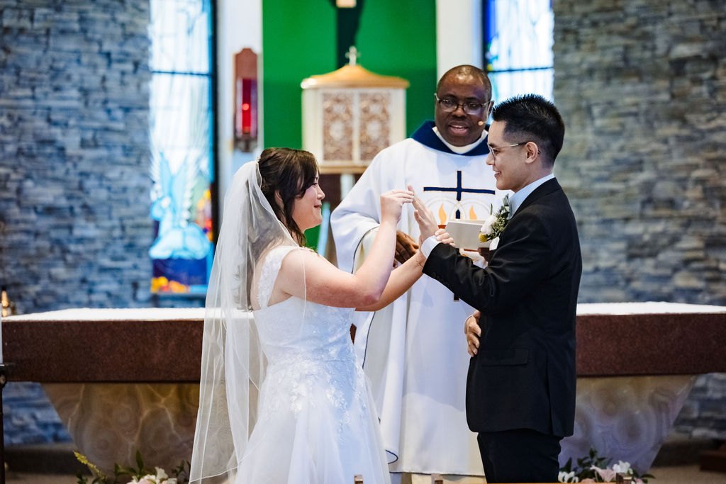 The couple presenting the gifts to the celebrant