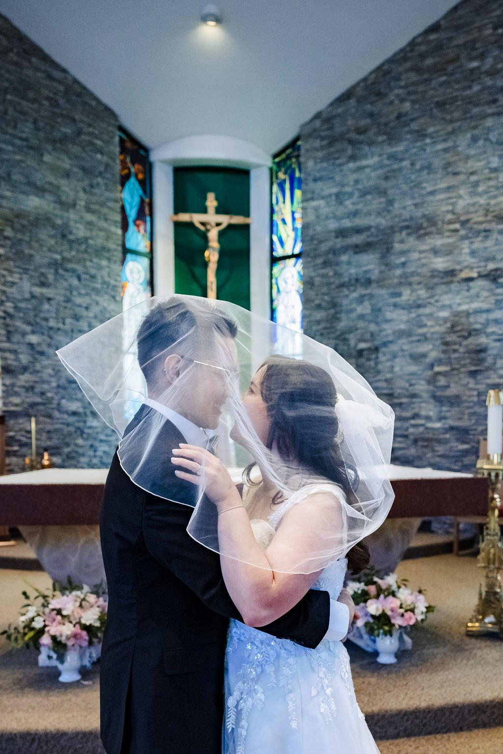 A veil kiss before the altar at St. Albert the Great
