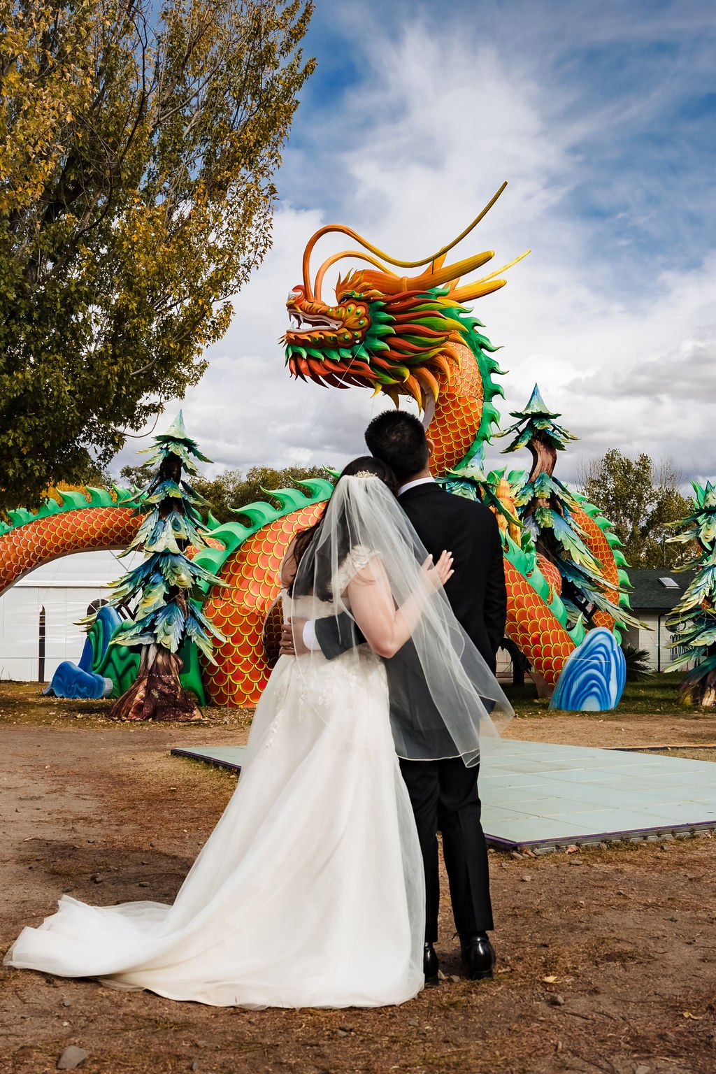 Vincent and Ginger beneath a giant dragon sculpture