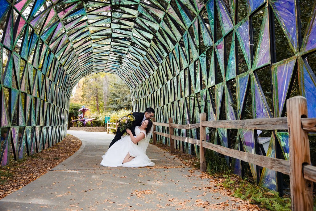 The couple inside a mosaic glass tunnel in the park