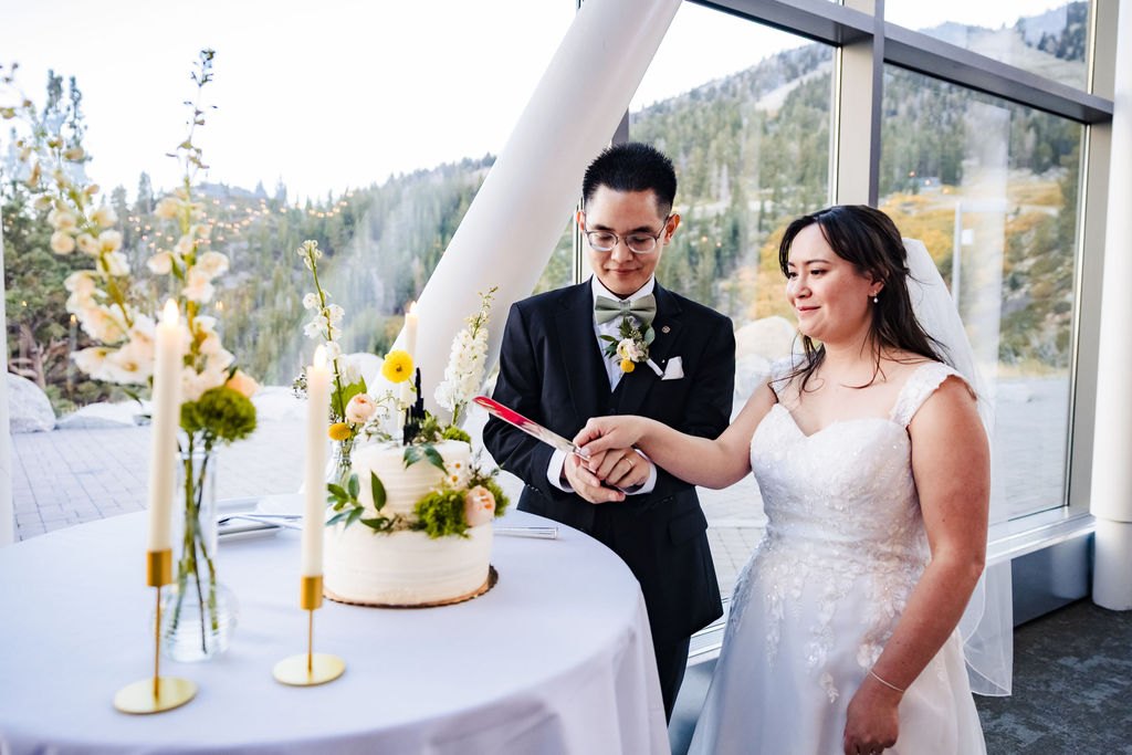 Vincent and Ginger cutting the cake by the windows