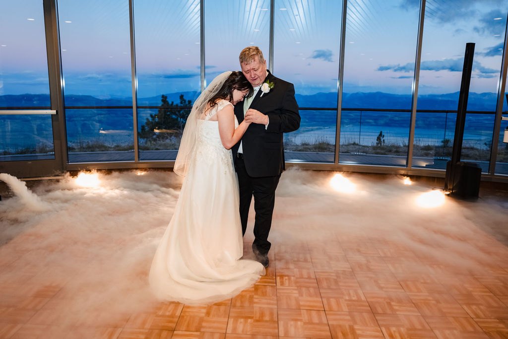 The first dance at dusk with the lake behind them